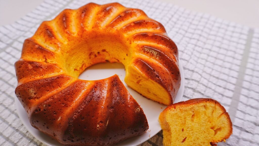 Condensed milk cake on a white plate and white towel